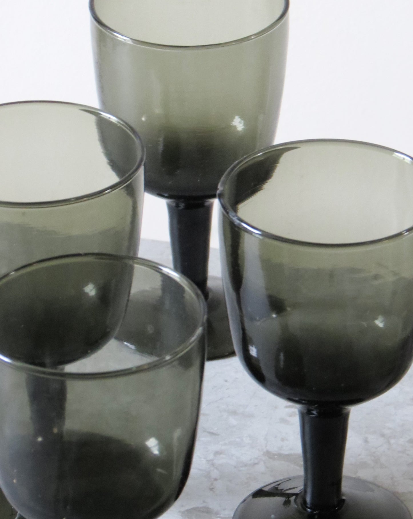 Set of four smoked wine glass  on a light background