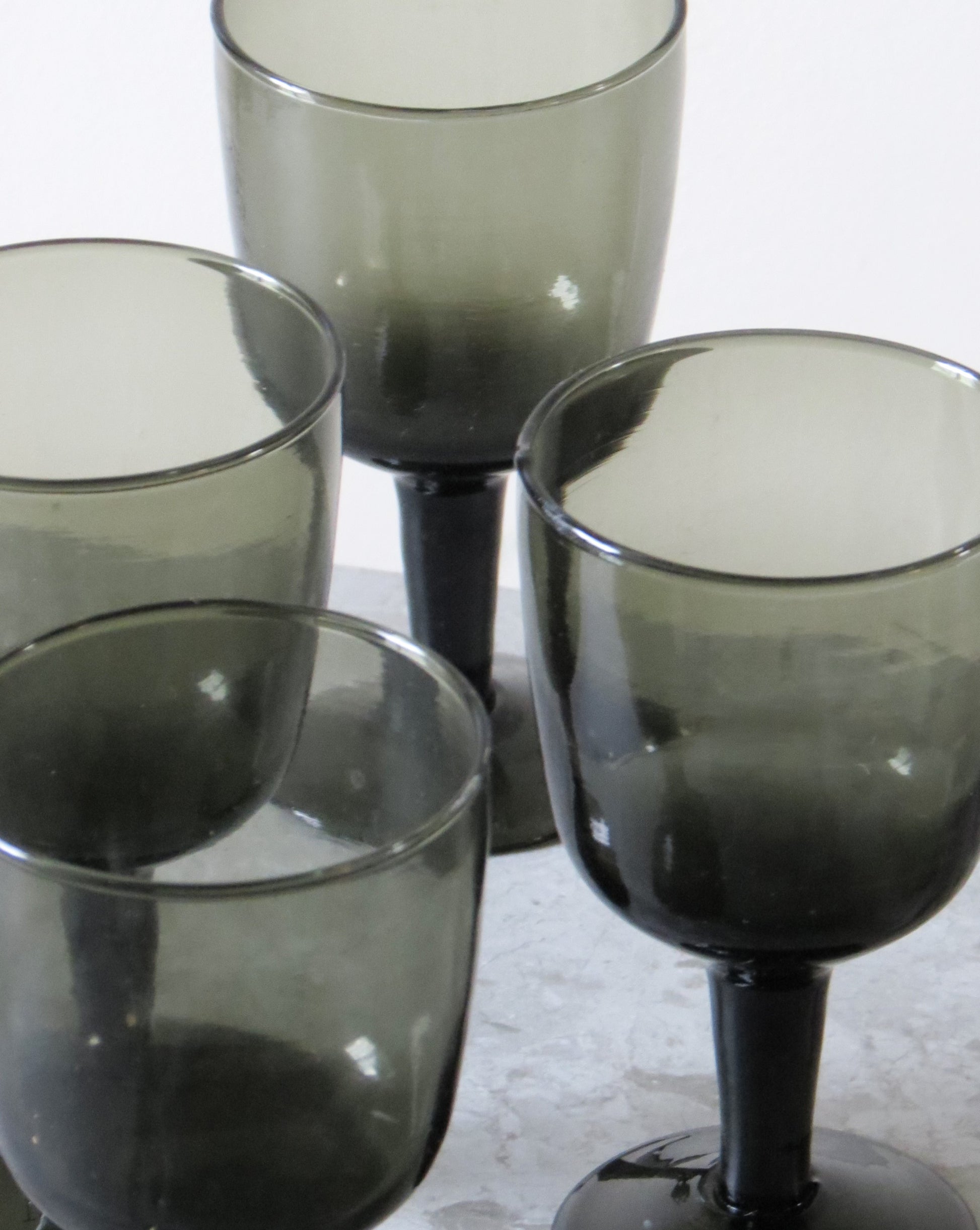 Set of four smoked wine glass  on a light background