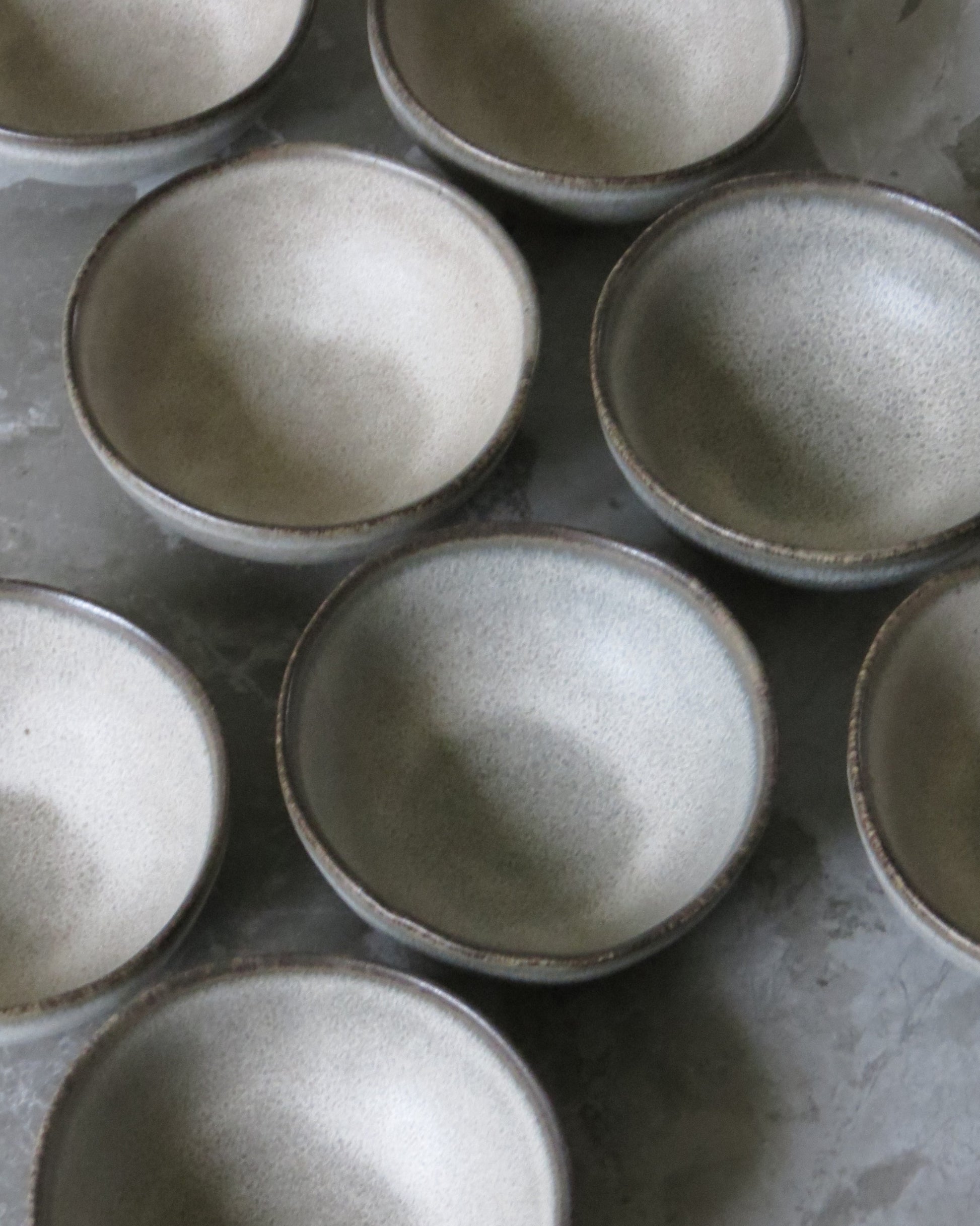 Set of ceramic bowls with a textured finish on a flat surface.