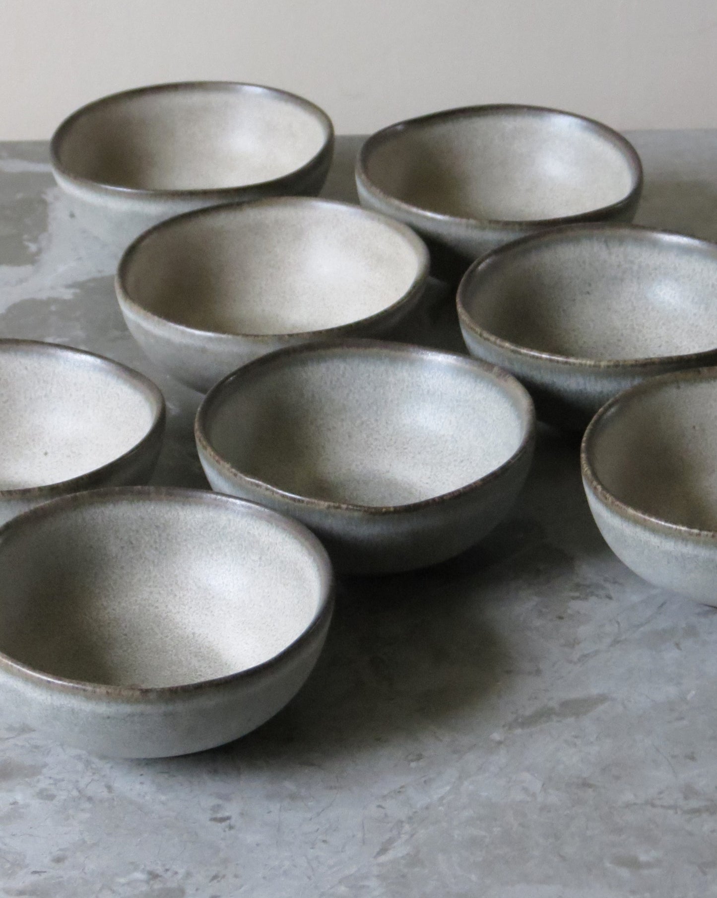 Set of ceramic bowls on a grey surface
