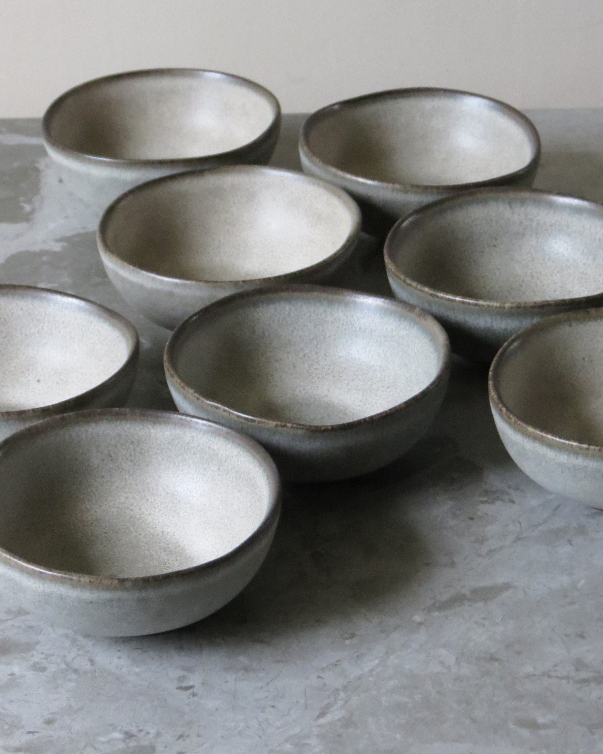 Set of ceramic bowls on a grey surface