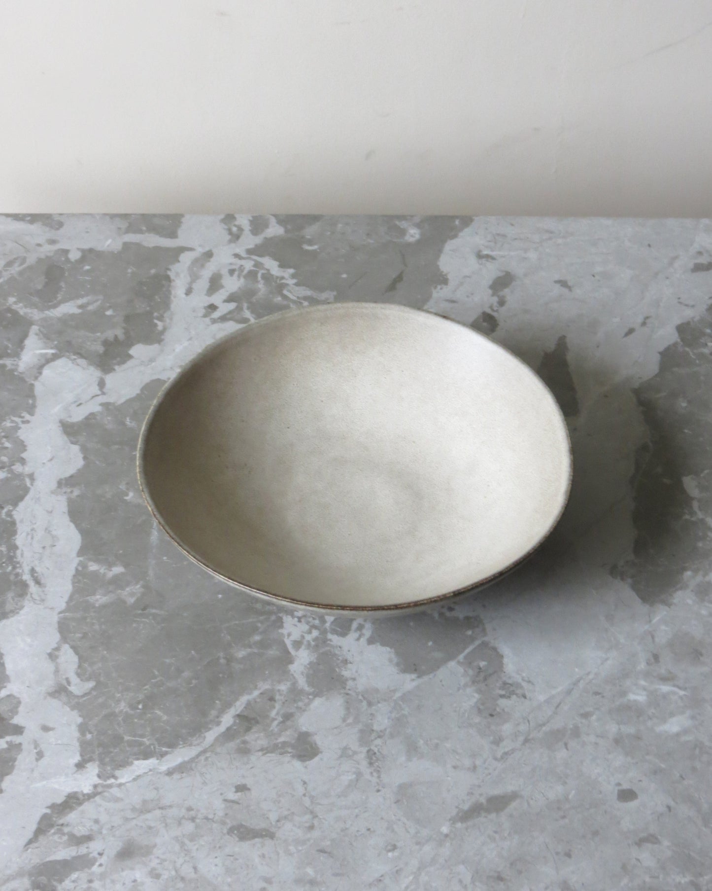 Silver bowl on a grey marble surface