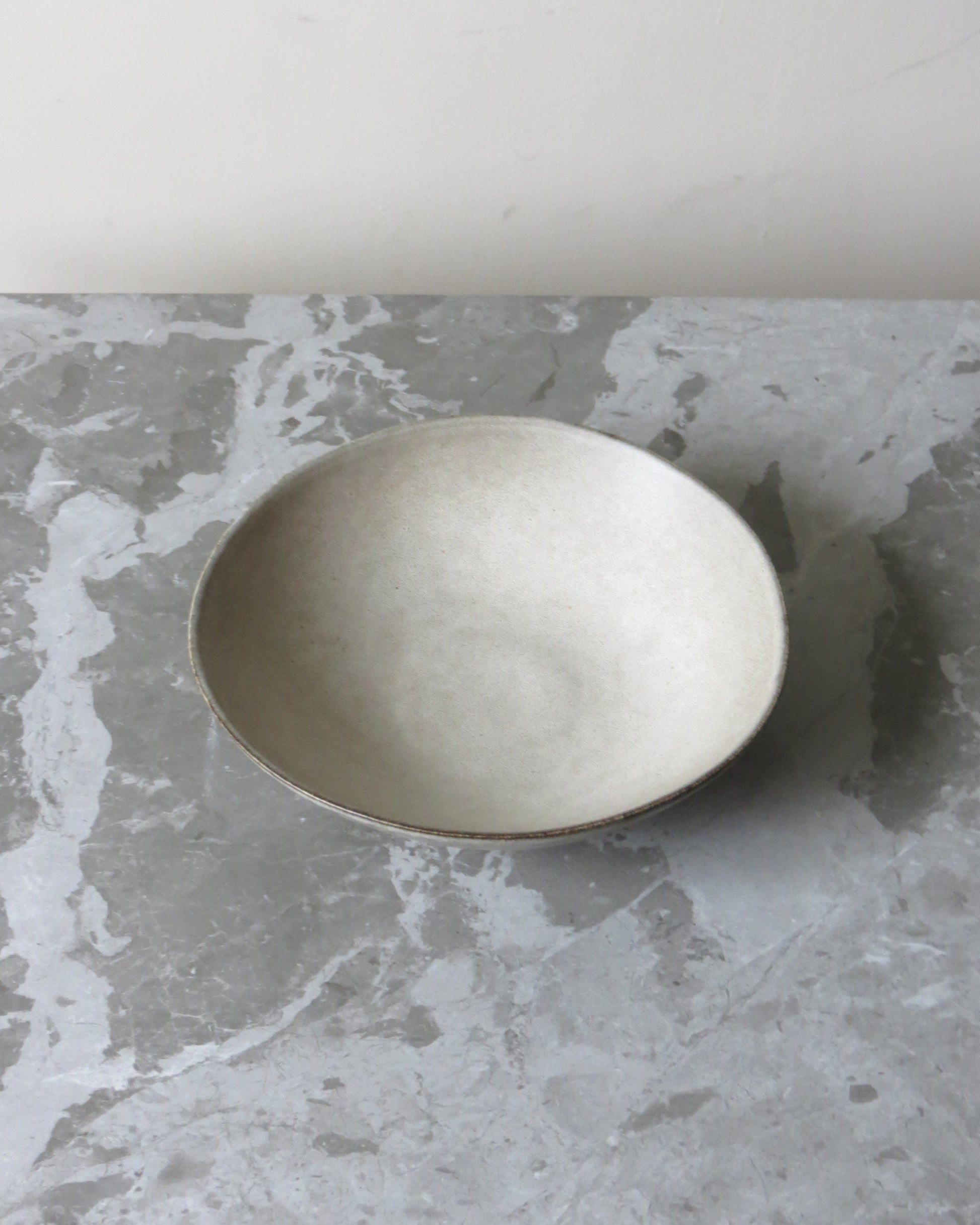 Silver bowl on a grey marble surface