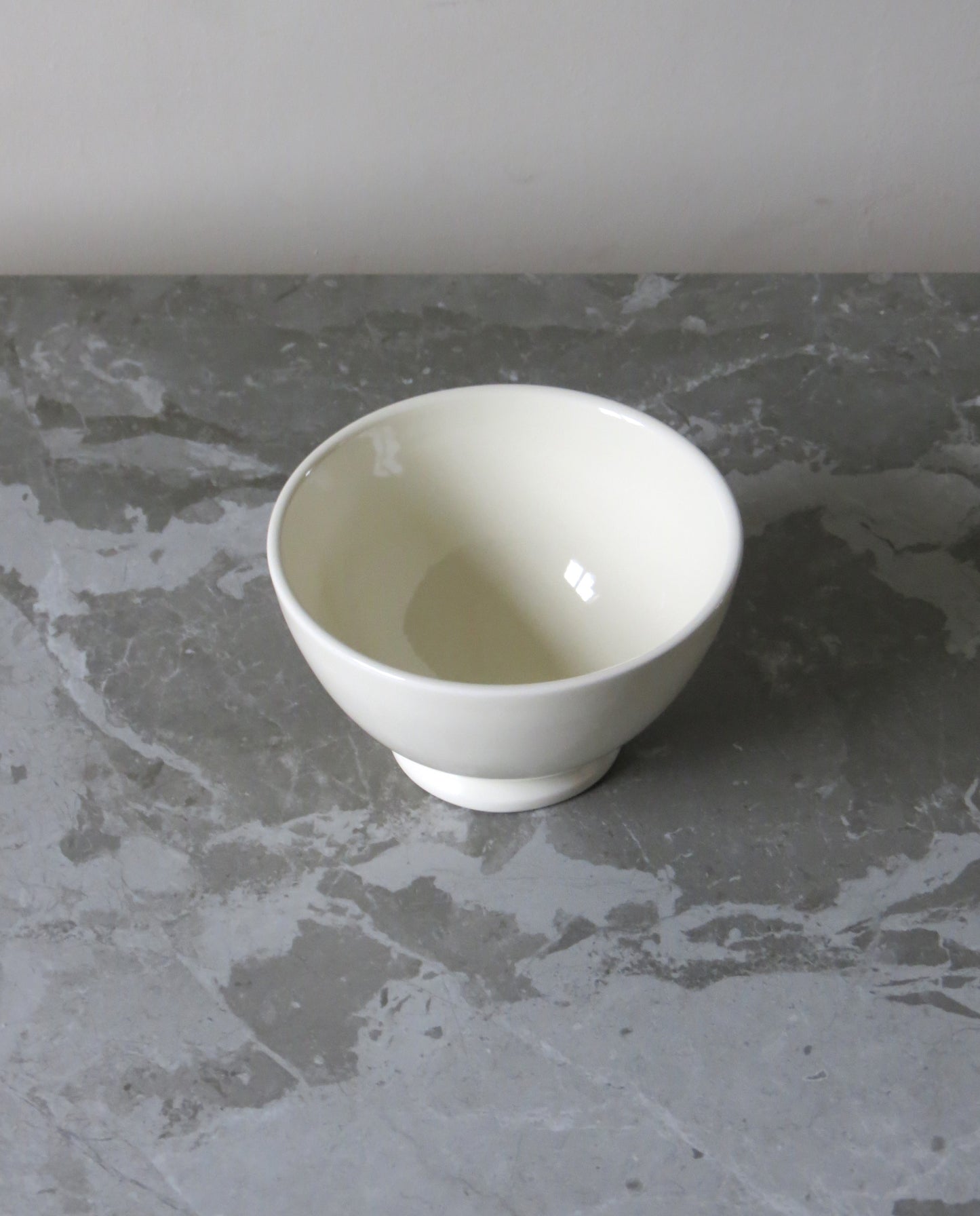 White ceramic bowl on a grey marble surface