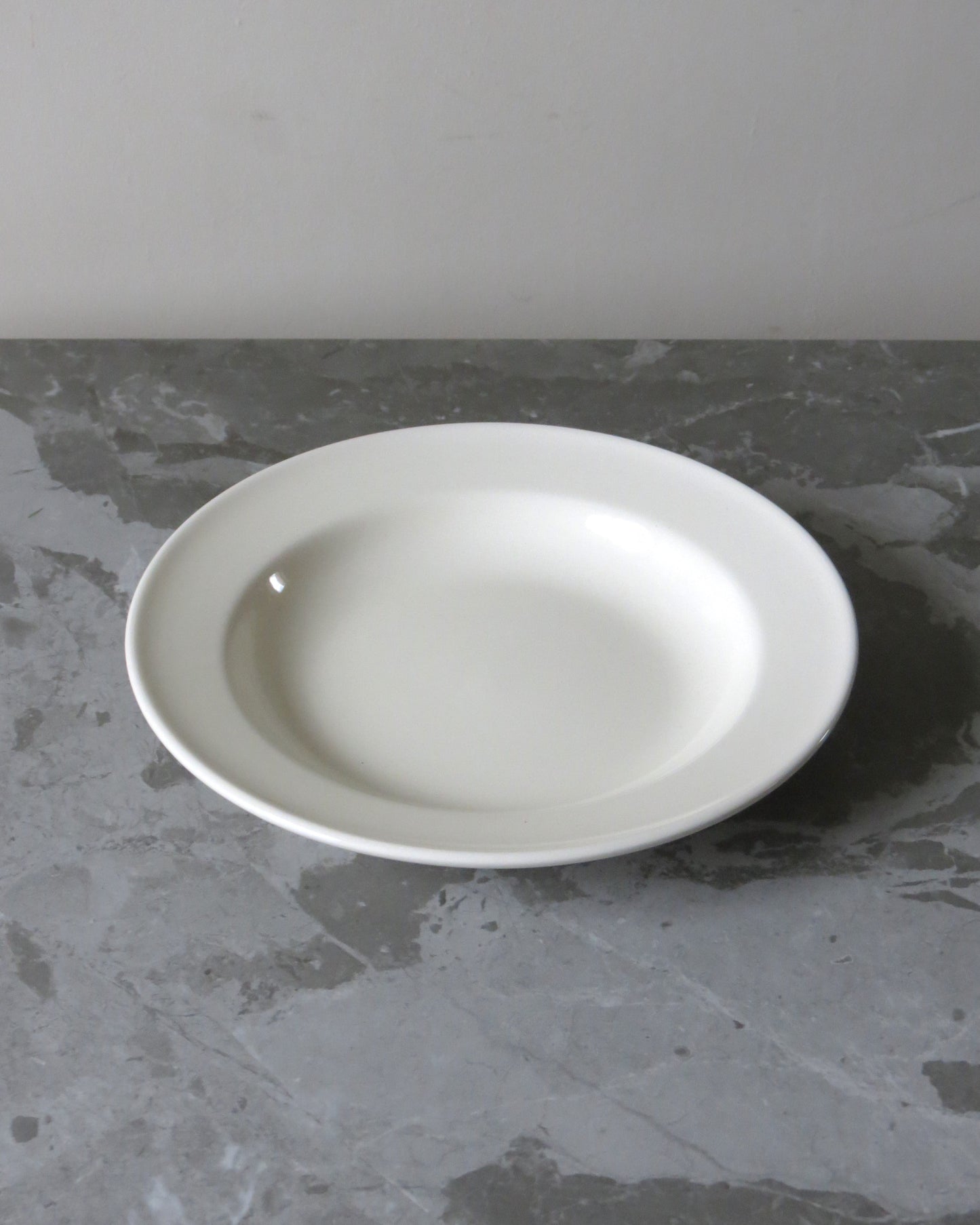 White ceramic plate on a grey stone surface