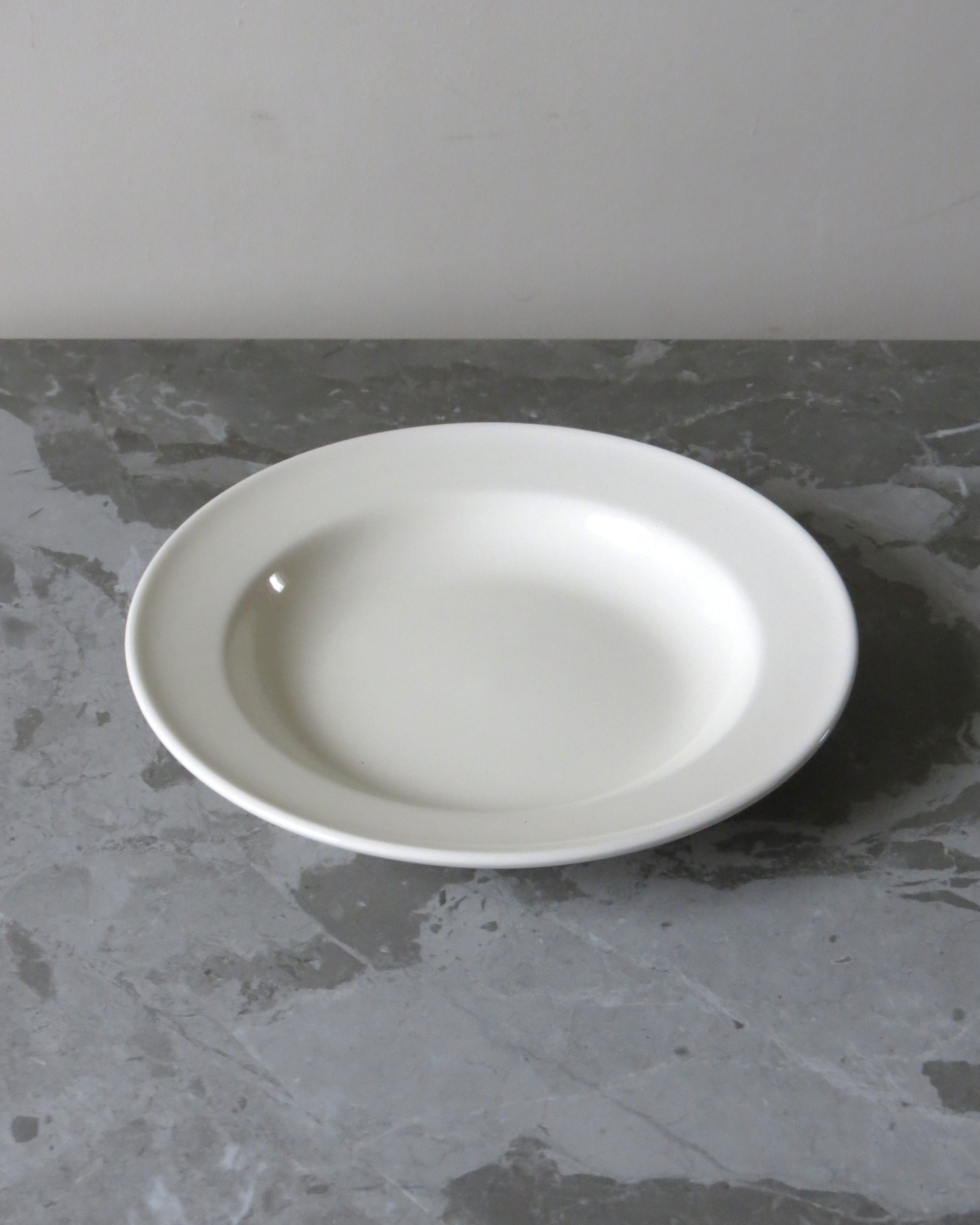 White ceramic plate on a grey stone surface
