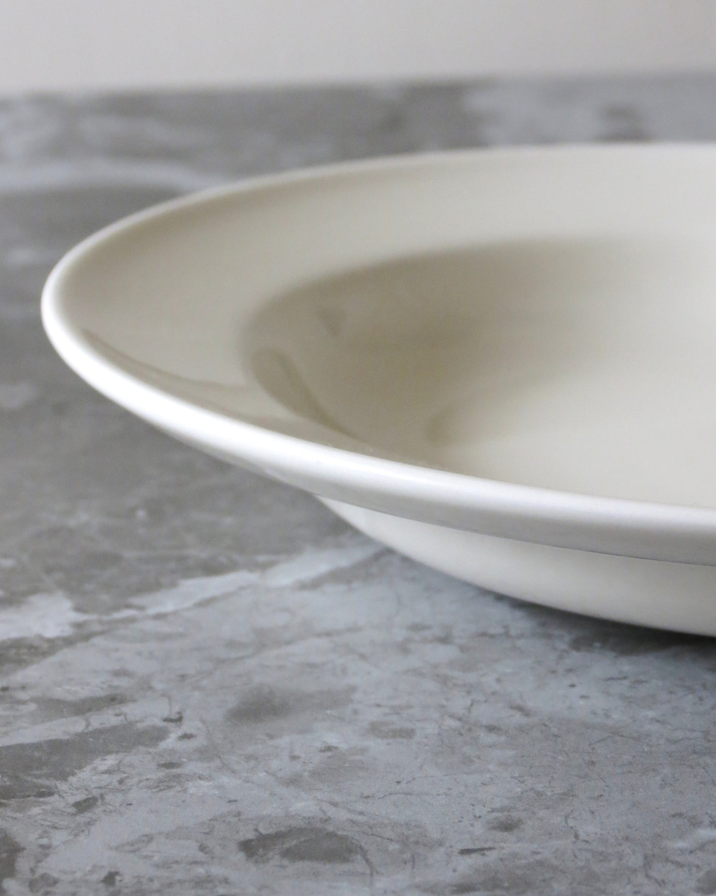 White ceramic bowl on a grey concrete surface