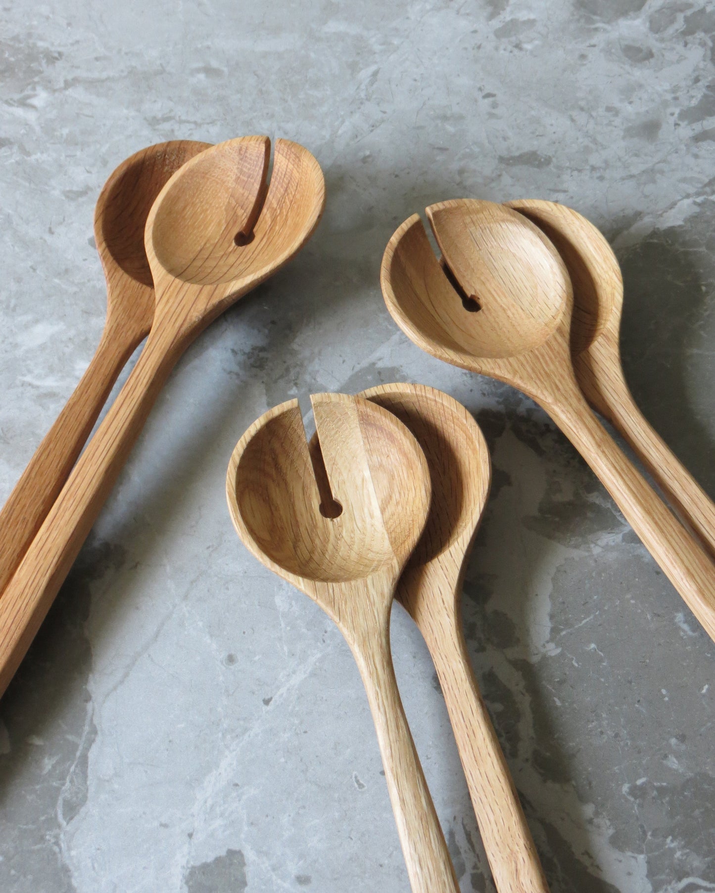Set of wooden spoons on a grey surface
