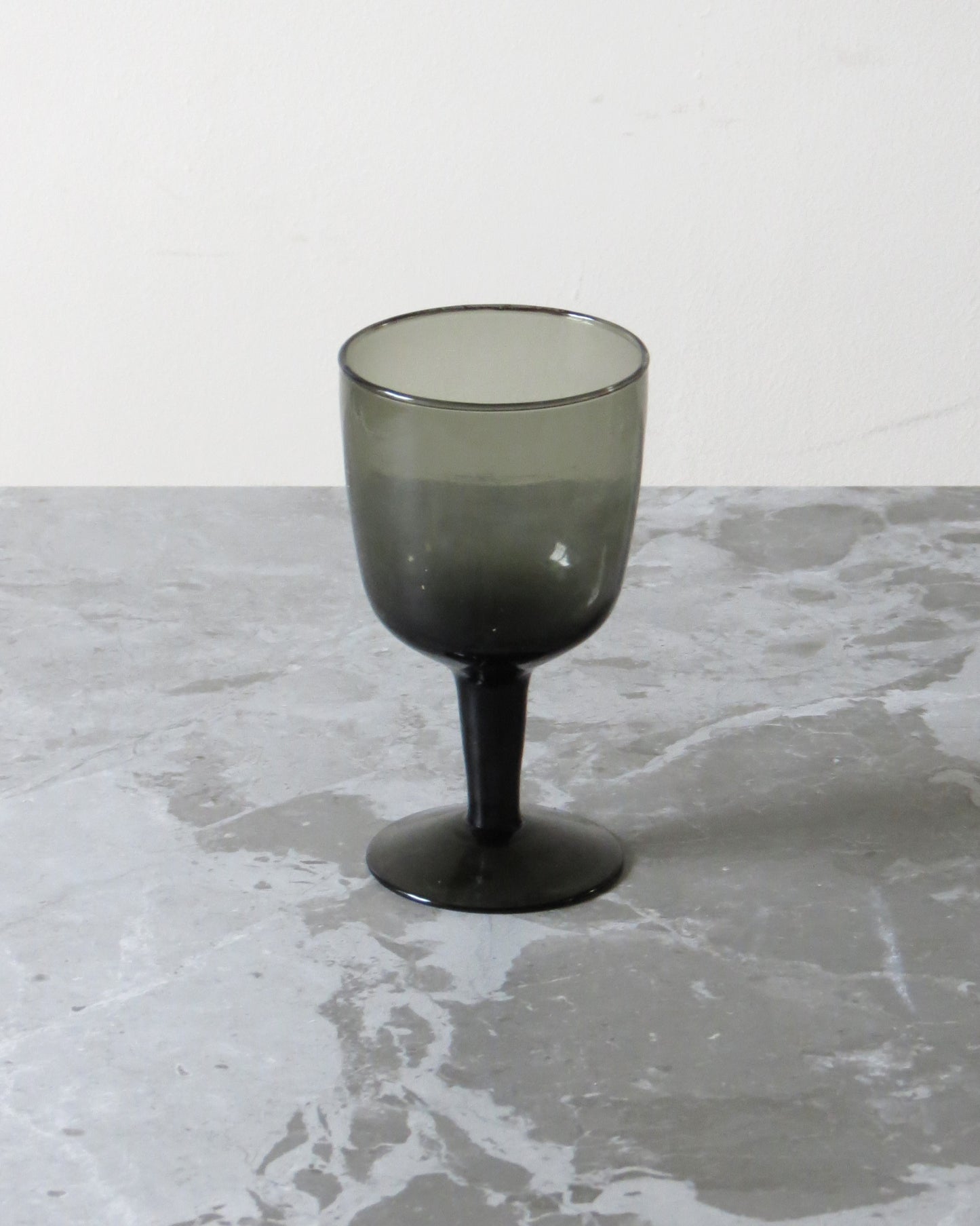 Smoked glass on a marble surface