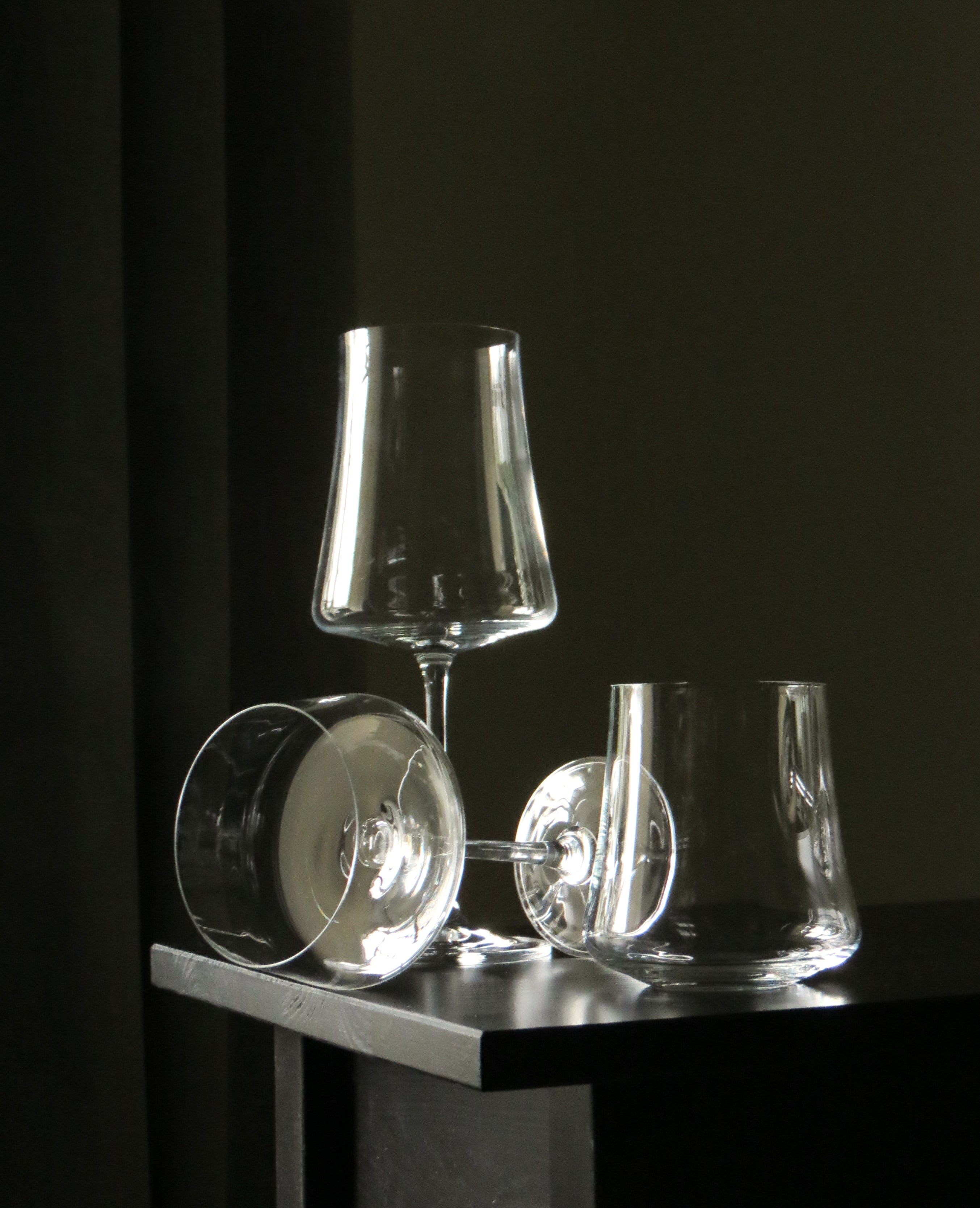 Glassware on Pedi stool. Dark back ground and curtain. 